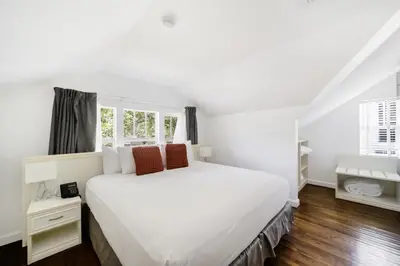 a white bedroom with a large white bed at Villa Italia by At Mine Hospitality in Miami Beach