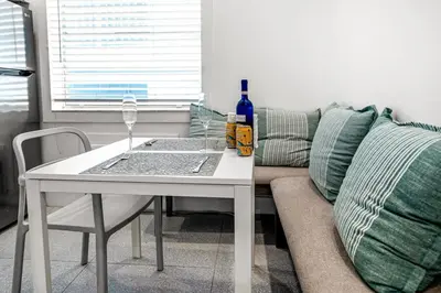 a living room with a white table and a couch at South of Fifth Oceanfront condo with Beach Perks! in Miami Beach