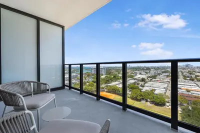 a balcony with chairs and a view of a city at Luxury Escape At 72 Park in Miami Beach