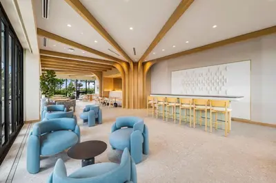 a lobby with blue chairs and tables and a whiteboard at Luxury Escape At 72 Park in Miami Beach