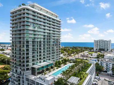 an aerial view of a tall building with a pool at Luxury Escape At 72 Park in Miami Beach