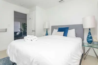 a bedroom with a large white bed with blue vases at Charming 3BR Getaway - Central Miami Location in Miami