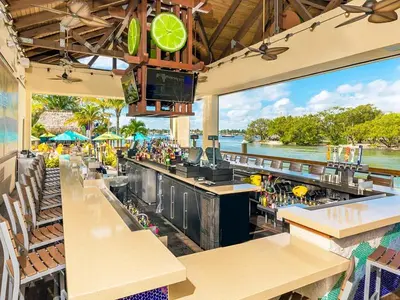 a restaurant with a bar with a view of the water at Charming Beachside Studio - Steps to the Beach in Hollywood