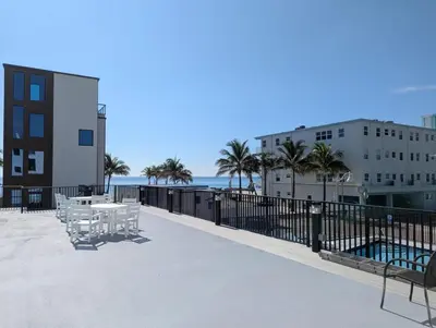 a patio with a table and chairs and the beach at Charming Beachside Studio - Steps to the Beach in Hollywood