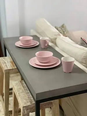 a table with three pink plates and cups on it at Right on the Beach Ocean Dr Secured Condo 206 in Miami Beach