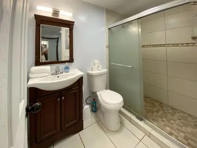 a bathroom with a toilet and a sink and a shower at Right on the Beach Ocean Dr Secured Condo 206 in Miami Beach