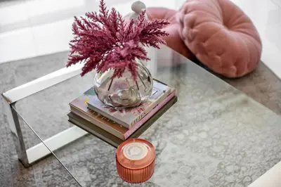 a glass table with a vase on top of books at W Hotel 2BR Ocean View, Pool, Spa, Free Gym Classes in Miami