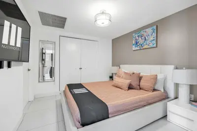a white bedroom with a large bed in it at W Hotel 2BR Ocean View, Pool, Spa, Free Gym Classes in Miami