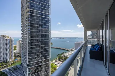 an apartment balcony with a view of the water at Wrap around Bay View, W Hotel Luxury 2BR 2BA, Pool, Spa, Free Gym Classes in Miami