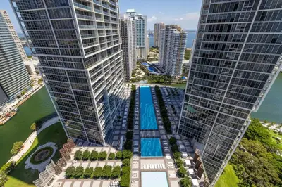an aerial view of two tall buildings with a pool between them at Wrap around Bay View, W Hotel Luxury 2BR 2BA, Pool, Spa, Free Gym Classes in Miami