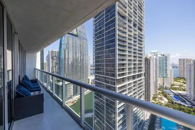 a balcony with a view of a tall building at Wrap around Bay View, W Hotel Luxury 2BR 2BA, Pool, Spa, Free Gym Classes in Miami
