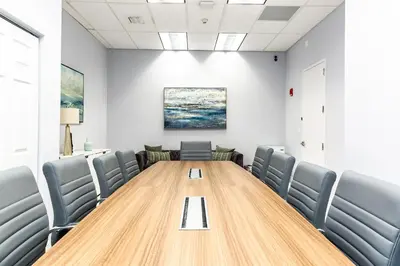 a conference room with a wooden table and chairs at Top Stay Miami Gold Brickell in Miami