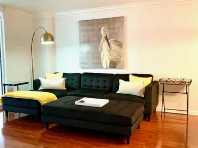 a living room with a green couch and a ottoman at Top Stay Miami Gold Brickell in Miami