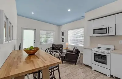 a kitchen and dining room with a table and chairs at Avocado House in Miami