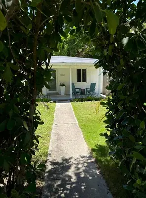 a garden path leading to a white house at Avocado House in Miami