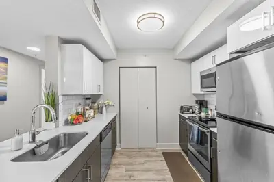 a kitchen with a sink and a refrigerator at 2Bedroom 2 Bath condo 10 Mins Walking To Jackson Memorial Hospital in Miami