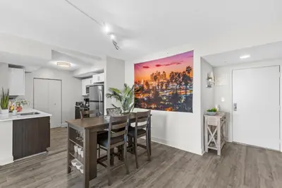 a kitchen and dining room with a large painting on the wall at 2Bedroom 2 Bath condo 10 Mins Walking To Jackson Memorial Hospital in Miami