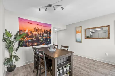 a dining room with a table and chairs and a painting at 2Bedroom 2 Bath condo 10 Mins Walking To Jackson Memorial Hospital in Miami