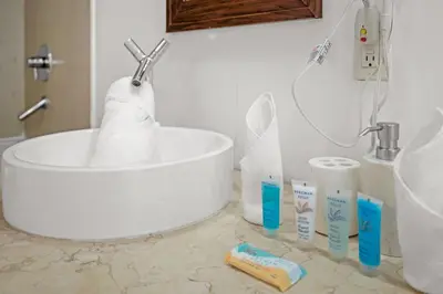 a bathroom with a sink and toiletries on a counter at Icon Brickell Retreat 1BR and Spa, Pool, Views in Miami
