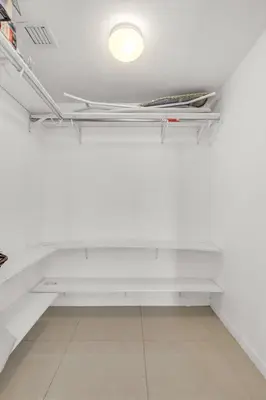a room with white shelves and a light on the ceiling at Icon Brickell Retreat 1BR and Spa, Pool, Views in Miami
