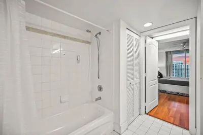 a white bathroom with a tub and a shower at Skyline and Bay Glimpse 1BR Brickell Retreat in Miami