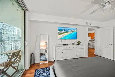 a bedroom with a bed and a tv on a wall at Skyline and Bay Glimpse 1BR Brickell Retreat in Miami