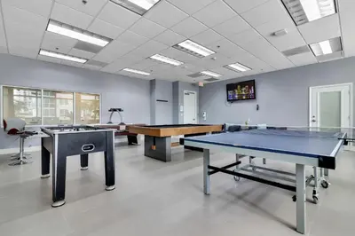 a room with two ping pong tables in it at Panoramic 2BR Bay-View in Brickell With Parking in Miami