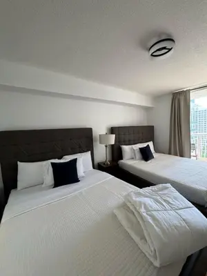 two beds sitting next to each other in a room at Elegant 1BR Condo at Brickell in Miami
