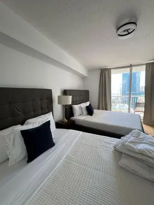 a hotel room with two beds and a window at Elegant 1BR Condo at Brickell in Miami