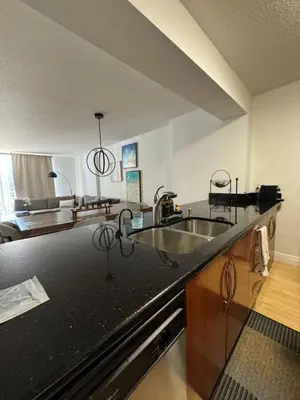 a kitchen with a black counter top and a sink at Elegant 1BR Condo at Brickell in Miami