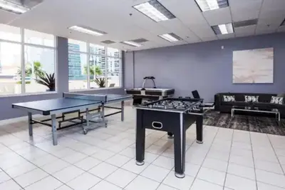 a room with two ping pong tables and a couch at Cozy 2BR Apt at Brickell free parking in Miami