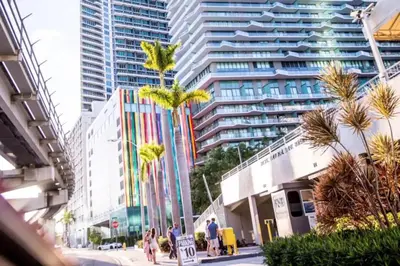 a city street with palm trees and tall buildings at Cozy 2BR Apt at Brickell free parking in Miami