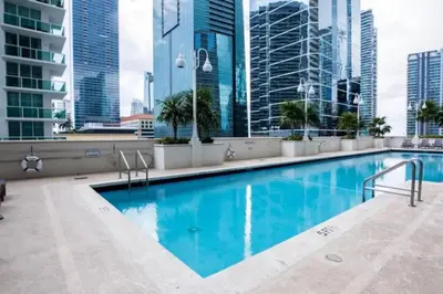 a swimming pool on the roof of a building with tall buildings at Awesome 4BR APT at Brickell in Miami