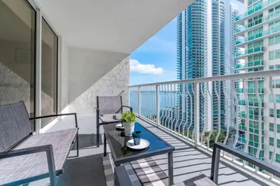 a balcony with two chairs and a table on a balcony at Awesome 4BR APT at Brickell in Miami