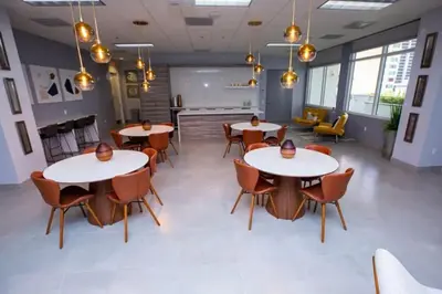 a room with tables and chairs in a building at Awesome 4BR APT at Brickell in Miami