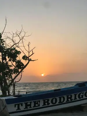 a boat on the beach with the sunset in the background at SPECTACULAR apt Brickell Miami FREE PARKING in Miami