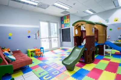 a play room with a slide and a couch at SPECTACULAR apt Brickell Miami FREE PARKING in Miami