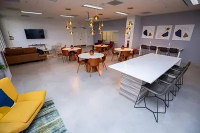a large room with tables and chairs and a couch at Lovely 2BR in the Heart of Brickell Free Parking in Miami