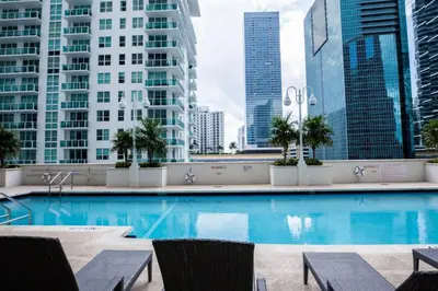 a swimming pool in a city with tall buildings at Lovely 2BR Rental in the Heart of Brickell in Miami