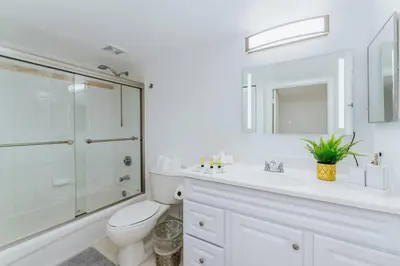 a white bathroom with a toilet and a glass shower at Amazing 2BR at Brickell Free Parking in Miami