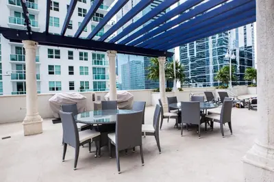 a patio with tables and chairs on a building at Amazing 2BR at Brickell Free Parking in Miami