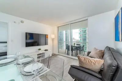 a living room with a couch and a glass table at 2bedroom ocean views brickell free parking in Miami