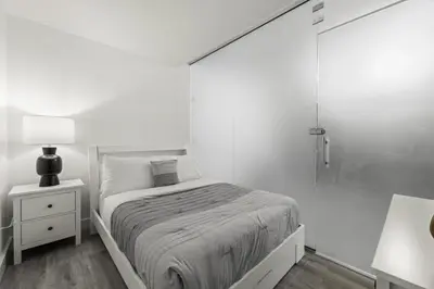 a white bedroom with a bed and a glass shower at Luxurious 2Bedroom Apt Parking in Brickell. in Miami