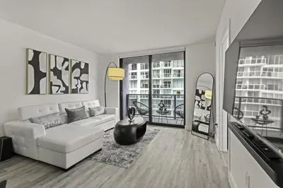 a living room with a white couch and two windows at Luxurious 2Bedroom Apt Parking in Brickell. in Miami