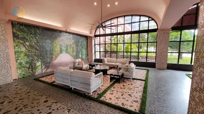 a living room with white furniture and a wall of windows at Alexander14192 in Miami Beach