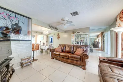 a living room with a couch and a table at 4 Mi to Hard Rock Stadium Miramar Home with BBQ! in Miramar
