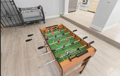 a table with a soccer game on top of it at Spacious Home With King Bed Near Stadium in Norland