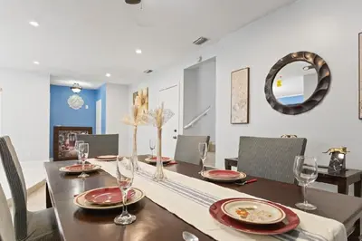 a dining room with a table and chairs and a mirror at Spacious Home With King Bed Near Stadium in Norland