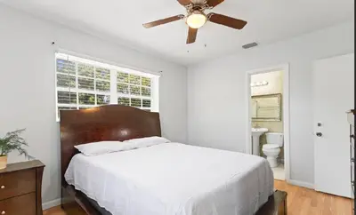 a bedroom with a bed and a ceiling fan at Spacious Home With King Bed Near Stadium in Norland