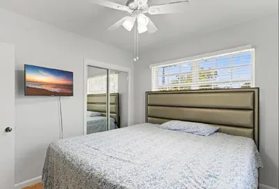 a bedroom with a bed and a ceiling fan at Spacious Home With King Bed Near Stadium in Norland
